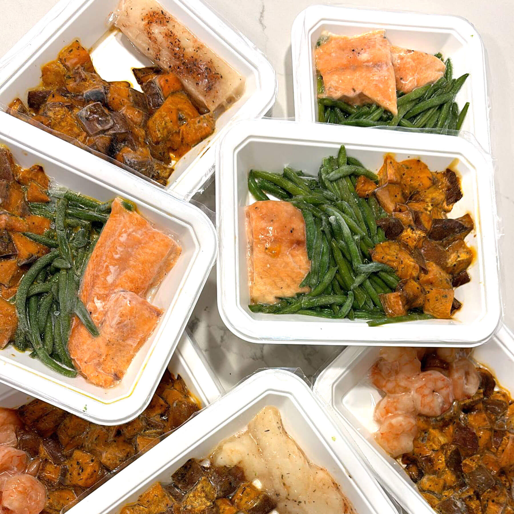 A collection of freshly prepared custom meals in containers