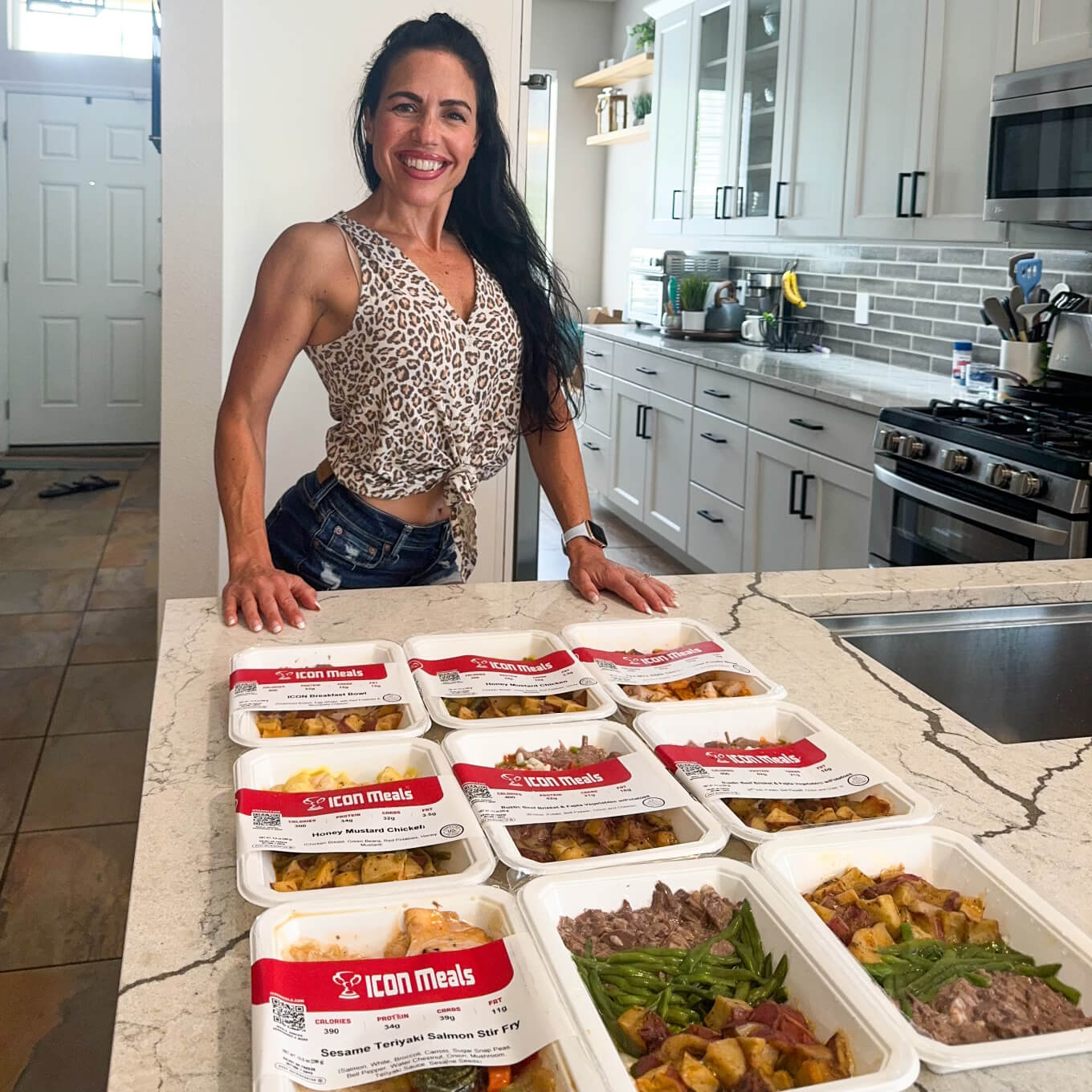 Brittni Shae with her weekly supply of ICON Meals meal prep